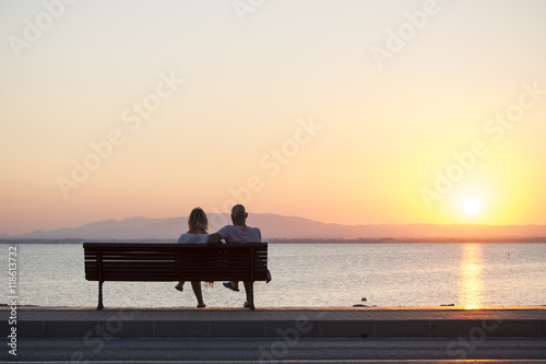 Couple of Tourist Sitting on Bench Watching the Sunset in La Manga, Mar Menor Side, Cabo de Palos, Cartagena and San Javier, Murcia, Spain, Europe