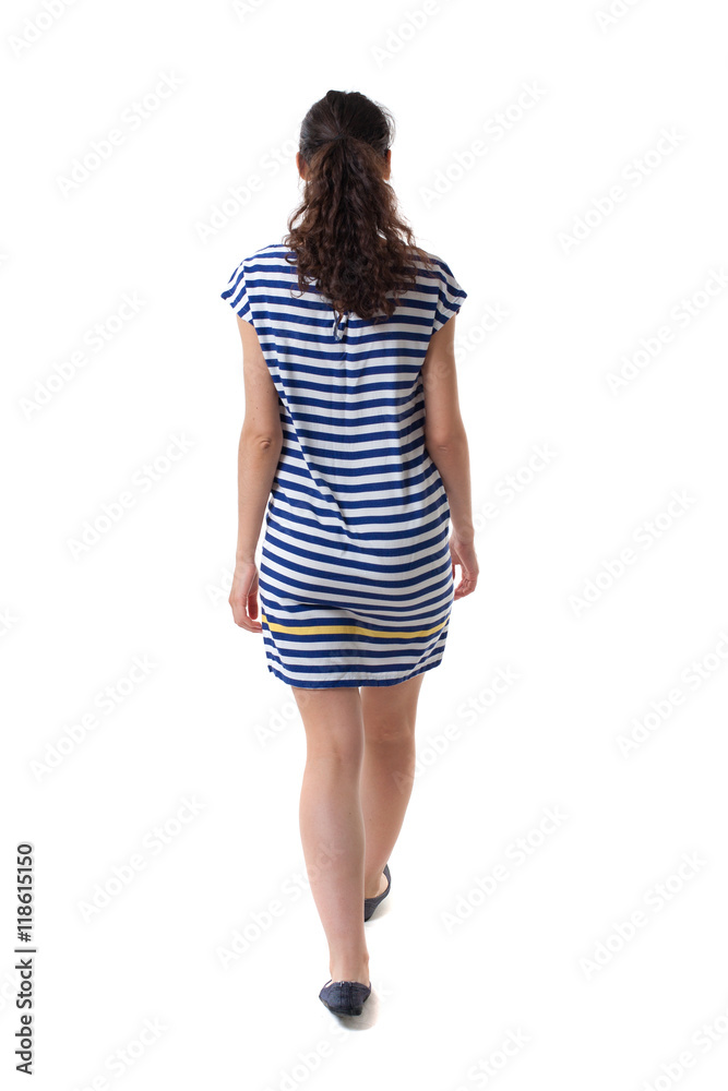 back view of walking curly woman. backside view of person. Rear view people collection. Isolated over white background. Swarthy girl in a checkered dress comes back to us. back view of walking curly woman. backside view of person. Rear view people collection. Isolated over white background. Swarthy girl in a checkered dress comes back to us.