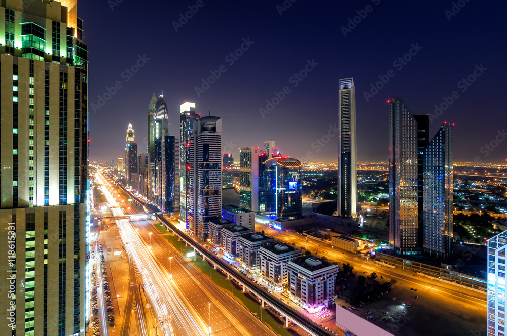 Fototapeta premium Amazing night dubai downtown skyline with tallest skyscrapers and traffic jam during rush hour, Dubai, United Arab Emirates
