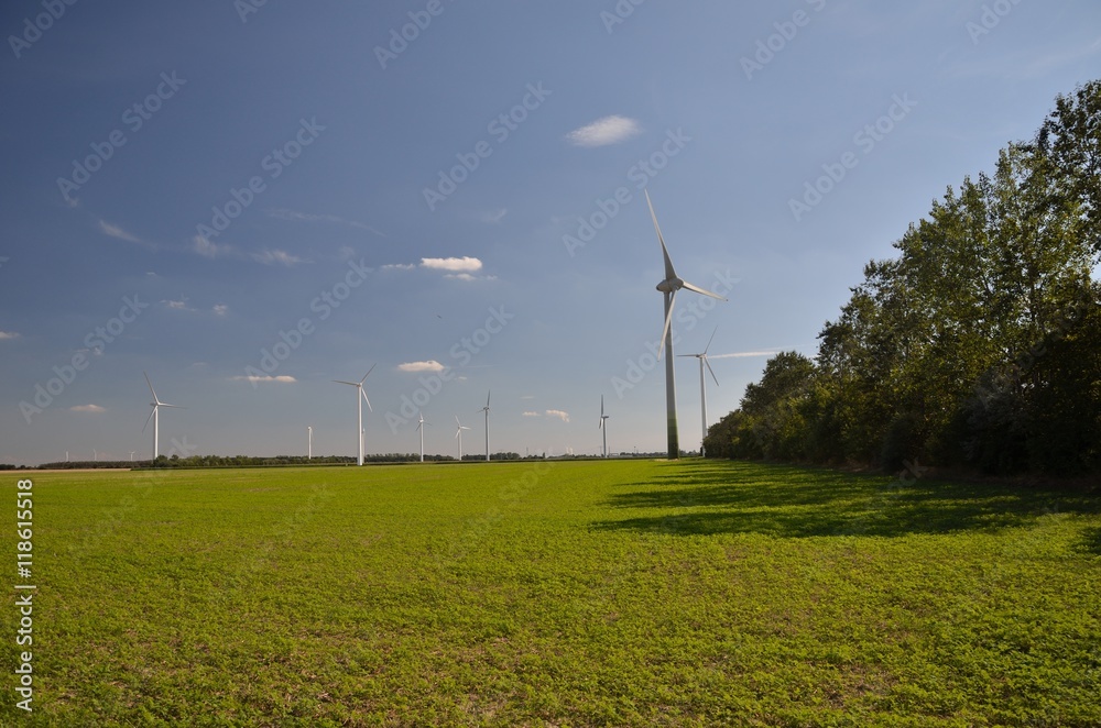 Green field wind turbines and blue sky Green field wind turbines and blue sky
