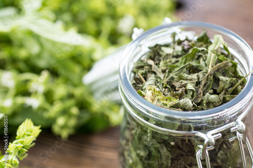 Basil leaves on wooden table in summer garden