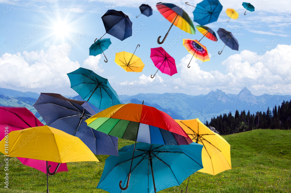 Naklejka premium Happiness, lust for life: flying colorful umbrellas on in front of blue sky :)
