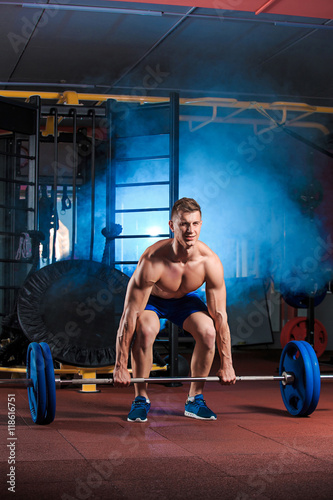 man doing exercises with barbell