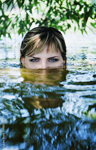 Fototapeta Naklejka Na Ścianę i Meble -  girl in a dark river water