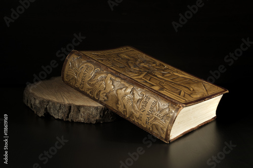 Miguel de Cervantes - Detail Old Embossed Leather Book Edition of The Ingenious Gentleman Don Quixote of La Mancha, Isolated on Dark Background