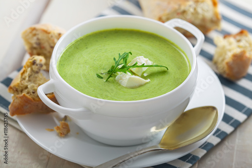 Cream soup made of broccoli on table. Traditional European food.