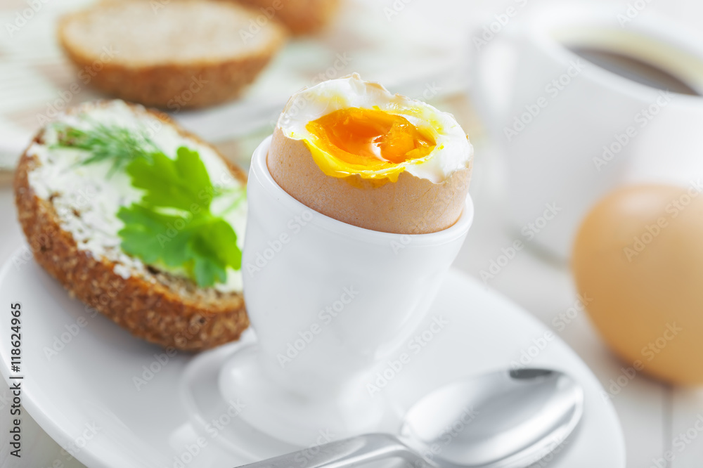 Traditional breakfast with perfect soft boiled egg, sandwich with butter and dill, coffee cup on a table. International cuisine food. Traditional breakfast with perfect soft boiled egg, sandwich with butter and dill, coffee cup on a table. International cuisine food.