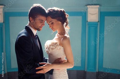 Man and woman hold each other tander while standing in the rays photo