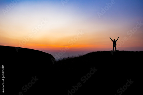 The man is show his hand in the sky at the morning on the mounta