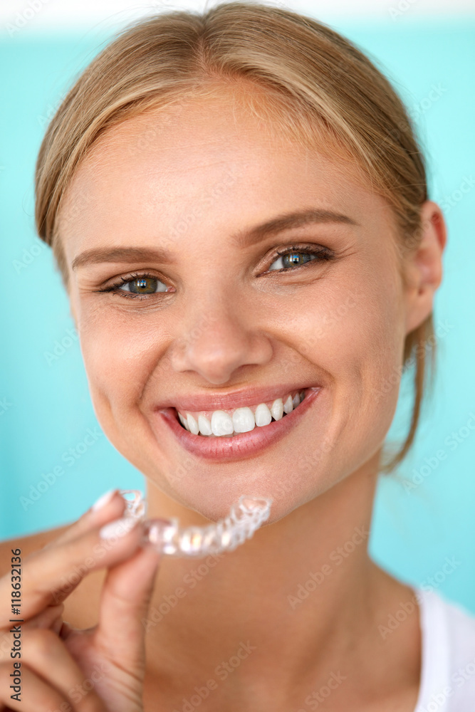 Smiling Woman With White Teeth Holding Teeth Whitening Tray. High Resolution Image Smiling Woman With White Teeth Holding Teeth Whitening Tray. High Resolution Image