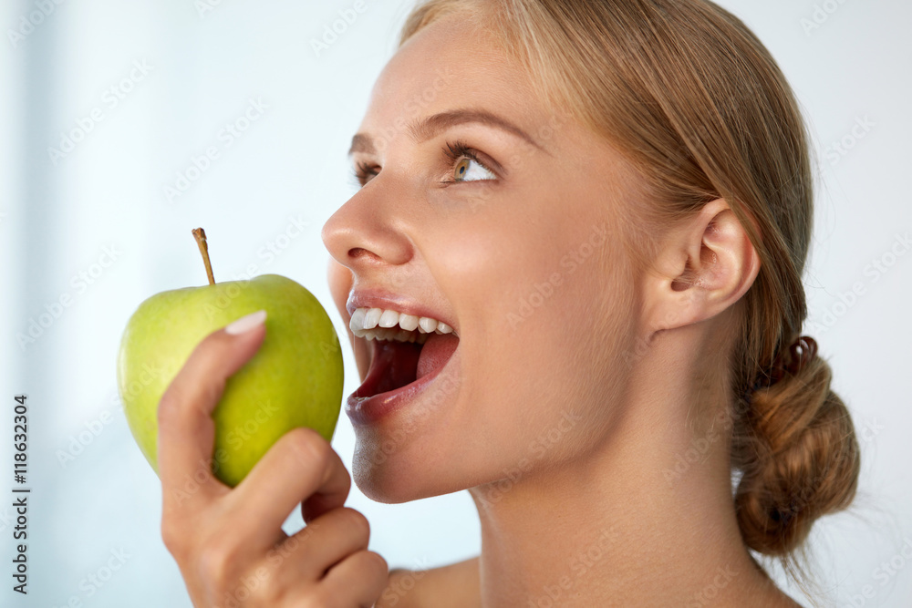 Woman Eating Apple. Beautiful Girl With White Teeth Biting Apple. High Resolution Image Woman Eating Apple. Beautiful Girl With White Teeth Biting Apple. High Resolution Image