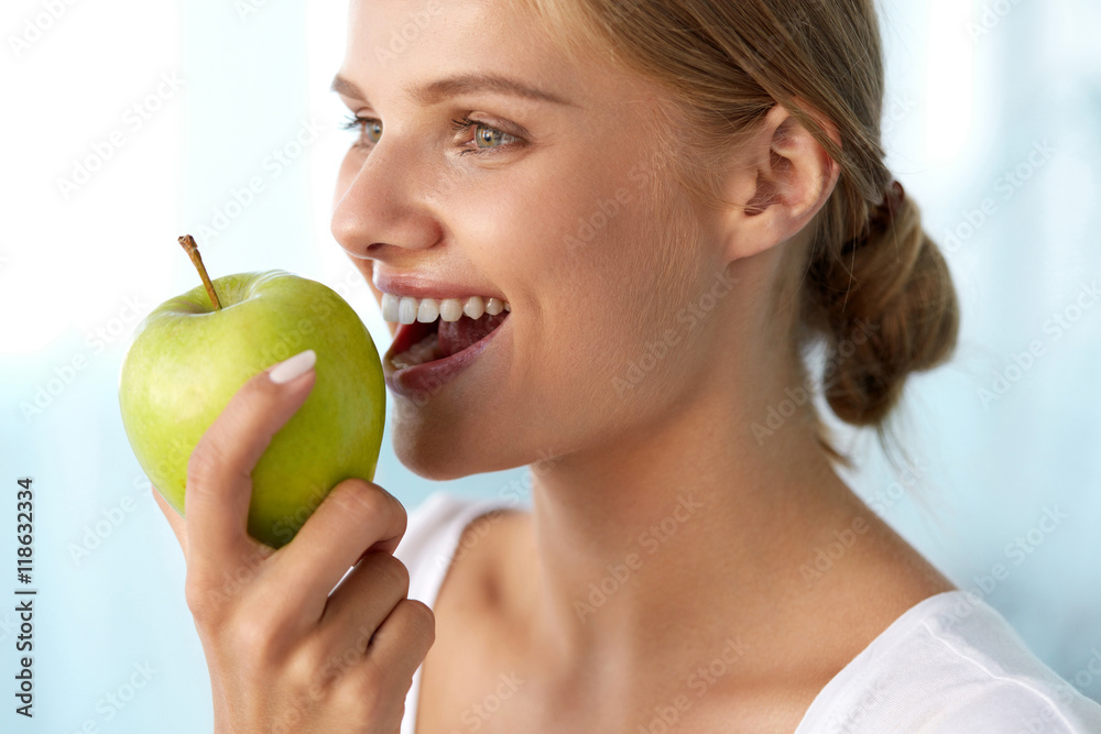 Woman Eating Apple. Beautiful Girl With White Teeth Biting Apple. High Resolution Image Woman Eating Apple. Beautiful Girl With White Teeth Biting Apple. High Resolution Image