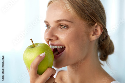 Woman Eating Apple. Beautiful Girl With White Teeth Biting Apple. High Resolution Image