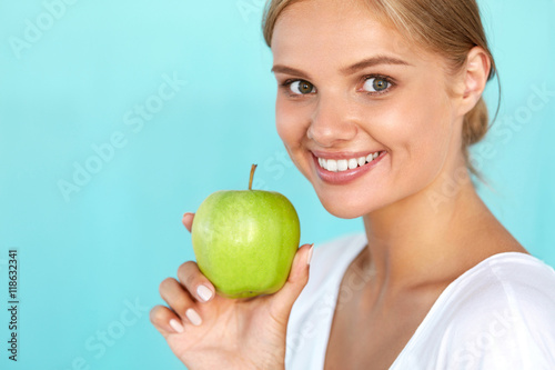 Woman With Apple. Beautiful Girl With White Smile, Healthy Teeth. High Resolution Image