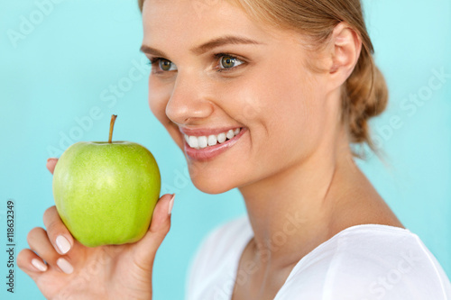 Smiling Woman With Beautiful Smile, White Teeth Holding Apple. High Resolution Image