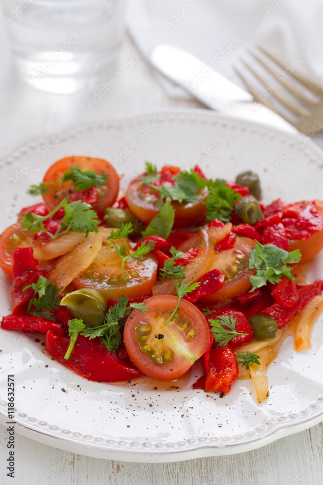 salad with tomato, red pepper and capers on plate