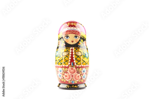 Wooden matryoshka doll painted in russian traditional style ornaments on white isolated background photo