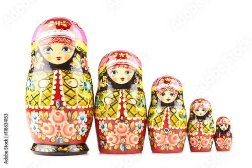 Five wooden matryoshka dolls painted in russian traditional style ornaments on white isolated background photo