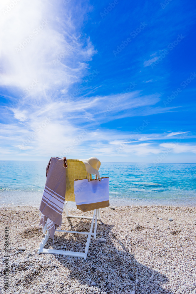 beach with deck chair, towel, bag, hat beach with deck chair, towel, bag, hat