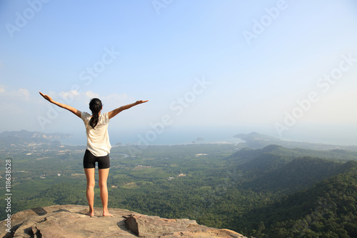 young fitness yoga woman at mountain peak