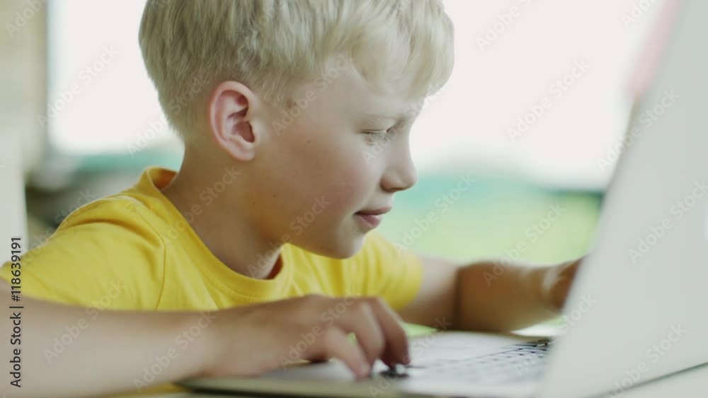 boy using laptop computer boy using laptop computer