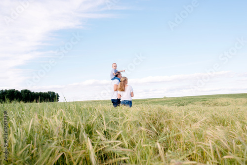 the happy family walks across the field
