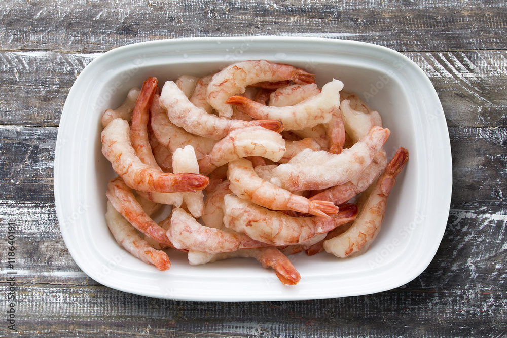 Fried shrimp with lemon on a white plate oven old wooden backgro Fried shrimp with lemon on a white plate oven old wooden backgro