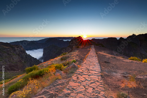 Sunset over mountains of Madeira island above the clouds at Pico do Arieiro and Pico Ruivo