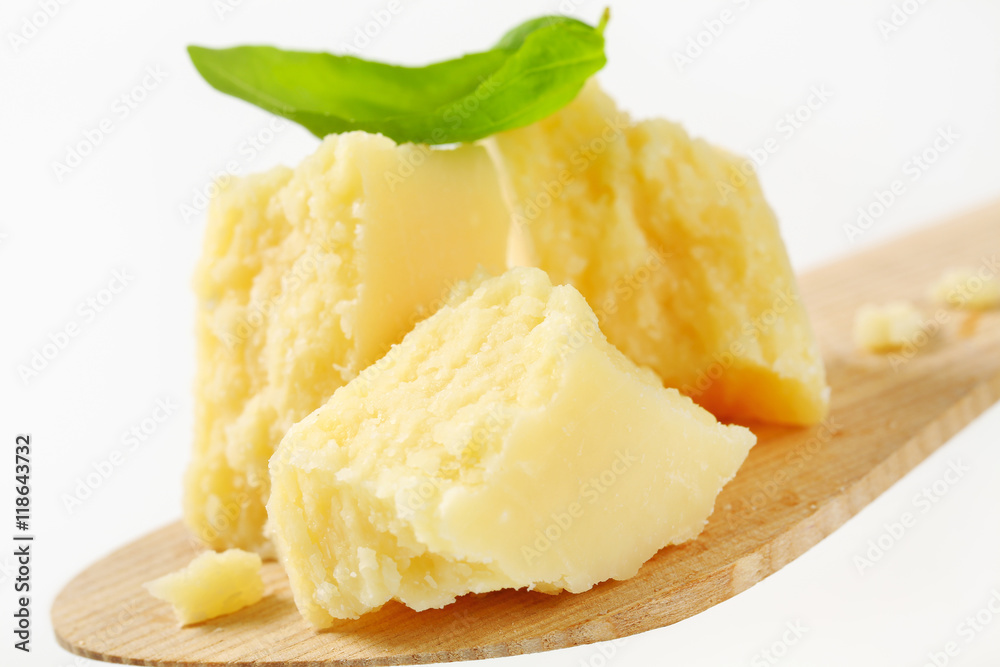 Parmesan cheese on wooden spatula Parmesan cheese on wooden spatula