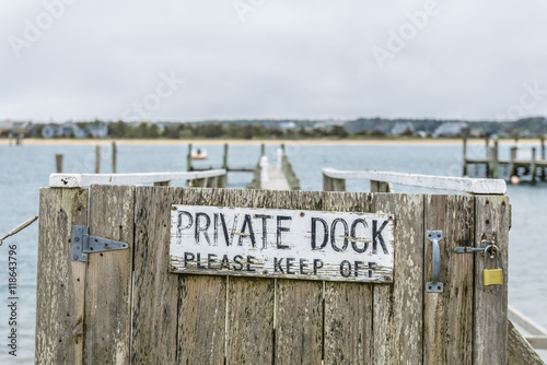 Private dock with keep out sign at a marina in a quaint New England seaside village.