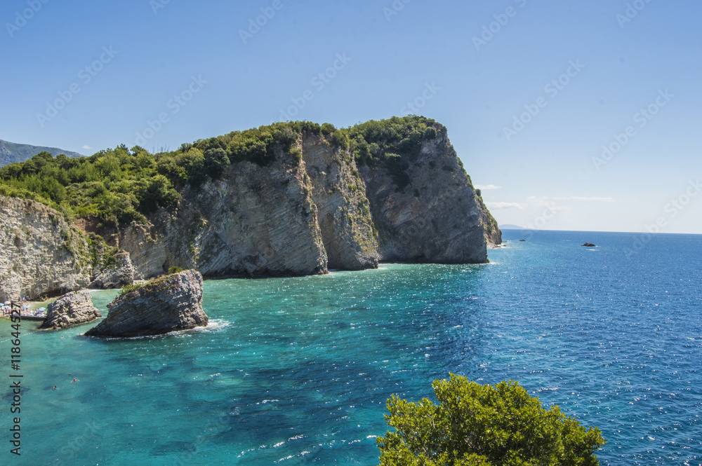 Rocky steep coast of the island of St. Nikola from the Adriatic Sea, near Budva, Montenegro