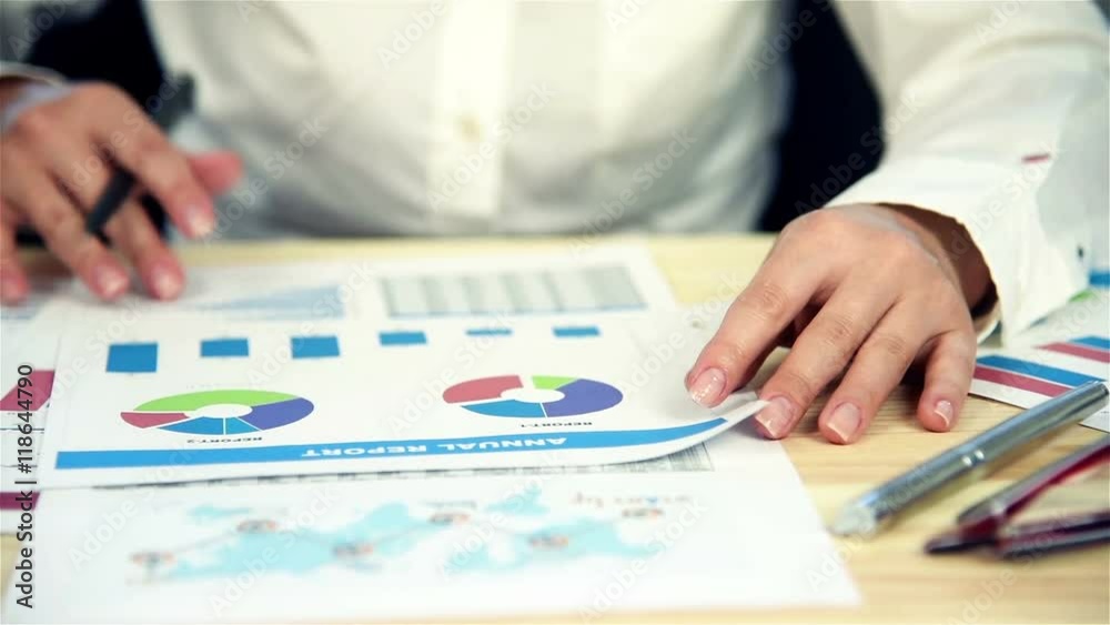 Businesswoman Doing Finances In Office. Analysis Of The Annual Report. Slow Motion Effect Businesswoman Doing Finances In Office. Analysis Of The Annual Report. Slow Motion Effect