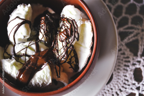 Delicious vanilla ice cream with hot chocolate.
