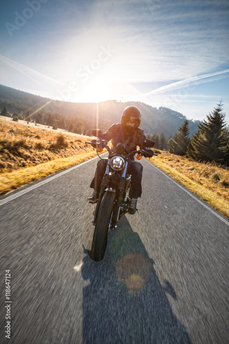 Motorcycle driver riding on motorway