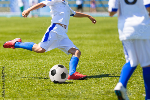 Fototapeta Naklejka Na Ścianę i Meble -  Youth players playing football soccer game. Running players in white uniforms