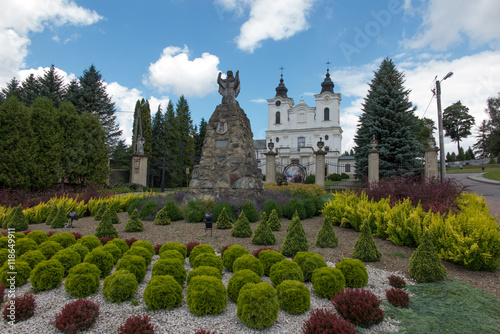 Dukla, Poland - July 22, 2016: Old statue of Mary in front of th photo