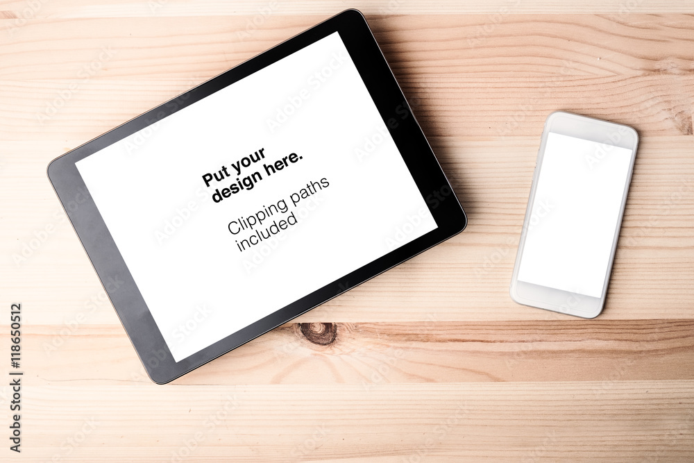 Tablet and smartphone on old wood desktop. Clipping paths includ Tablet and smartphone on old wood desktop. Clipping paths includ