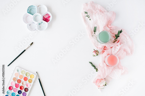 workspace. watercolor, paintbrush, palette, tools and roses with textile on white background. Overhead view. Flat lay, top view