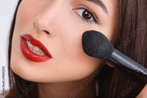 Картината върху платно Happy girl doing visage with brush