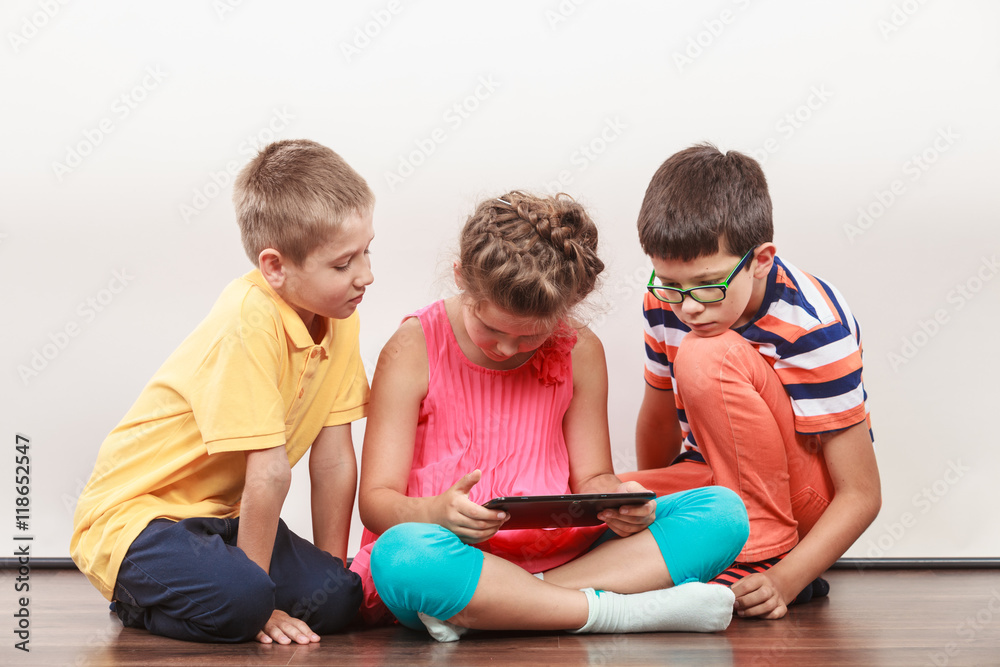 Fototapeta premium Kids playing on tablet.