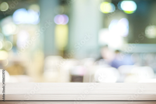 Empty white wood table and blurred cafe with bokeh background