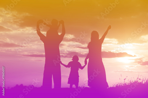 Happy family dancing on the road in the sunset time. Evening par