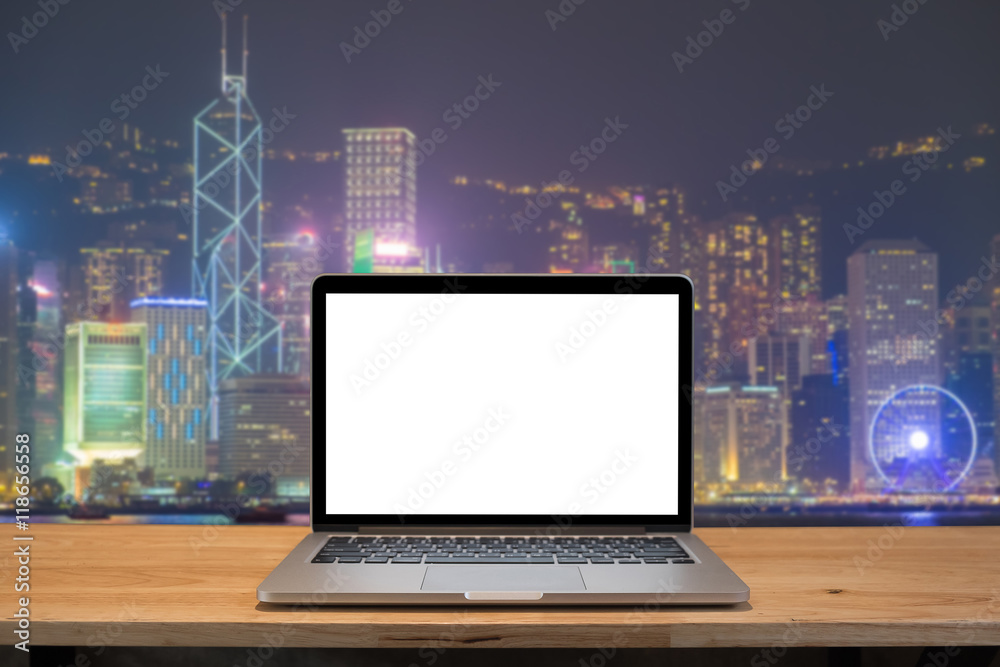 Laptop with blank screen on table. hongkong night city backgroun Laptop with blank screen on table. hongkong night city backgroun