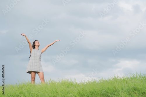 Carefree woman having a good time at the meadow