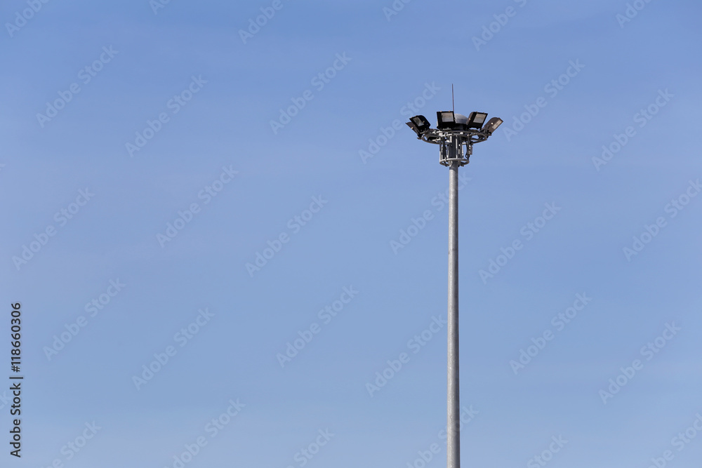 Circular Spotlight Pole on blue sky background.
