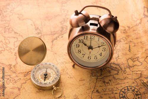 Compass and alarm clock classic style on old map