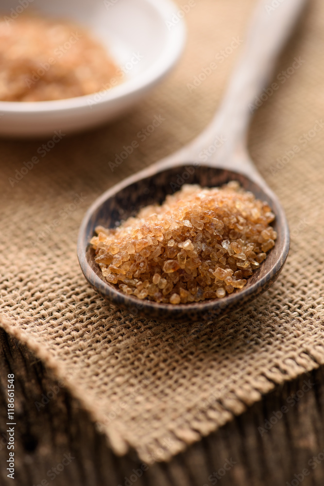 Raw Organic Cane Sugar in a wooden spoon Raw Organic Cane Sugar in a wooden spoon