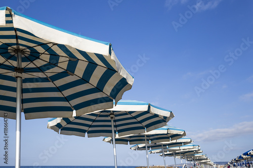 Beach with umbrellas at the first light of day in Italy