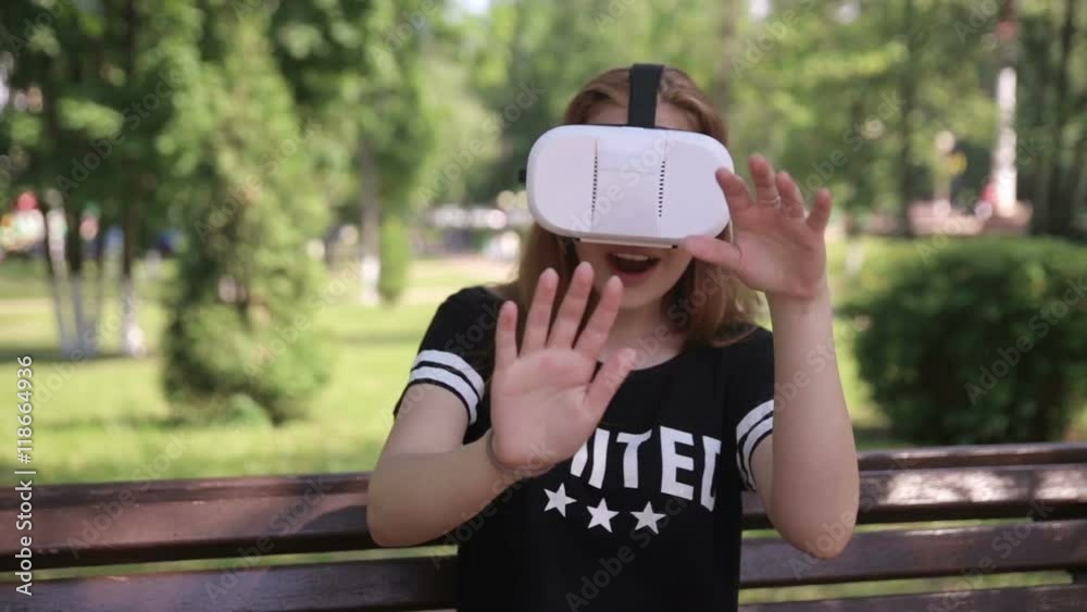Young woman playing game using VR-helmet for smart phones. Virtual space, augmented reality device. 1080p. Young woman playing game using VR-helmet for smart phones. Virtual space, augmented reality device. 1080p.