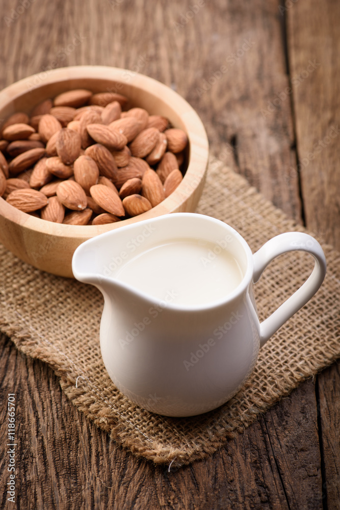 Almond milk in glass with almonds Almond milk in glass with almonds